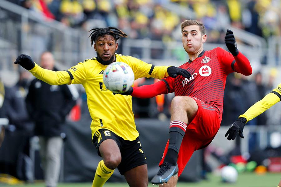 Columbus Crew defender Steven Moreira, left, and Toronto FC midfielder Luca Petrasso vie for the ball during the second half of an MLS soccer match.