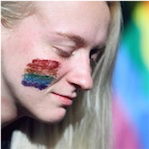 student with pride flag face paint