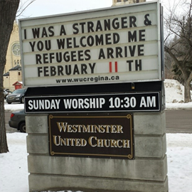 Westminster United Church Street Sign: I was a stranger & You welcomed me refugees arrive Feb 11th