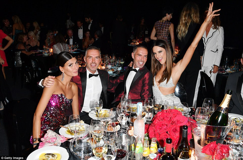 In high spirits: Alessandra threw her hands in the air in celebration of fashion's big night out