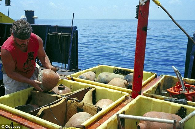 Handle with care: Team members examine containers full of ceramic jars from the Buen Jesus