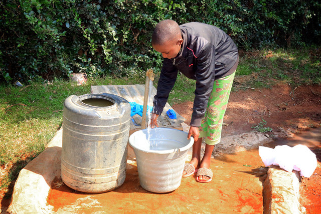 Josephine Kwamboka, 12, fetches water from a tap installed by First United Methodist Church of Moheto, Kenya. Prior to the installation of the well, children traveled great distances each day to find water in streams and ponds. Waterborne illnesses have decreased significantly since the well was drilled. Photo by Gad Maiga, UM News.​