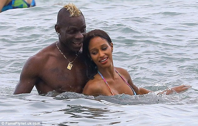 Close contact: The Italian striker looked delighted with himself as he had fun with Fanny in the water