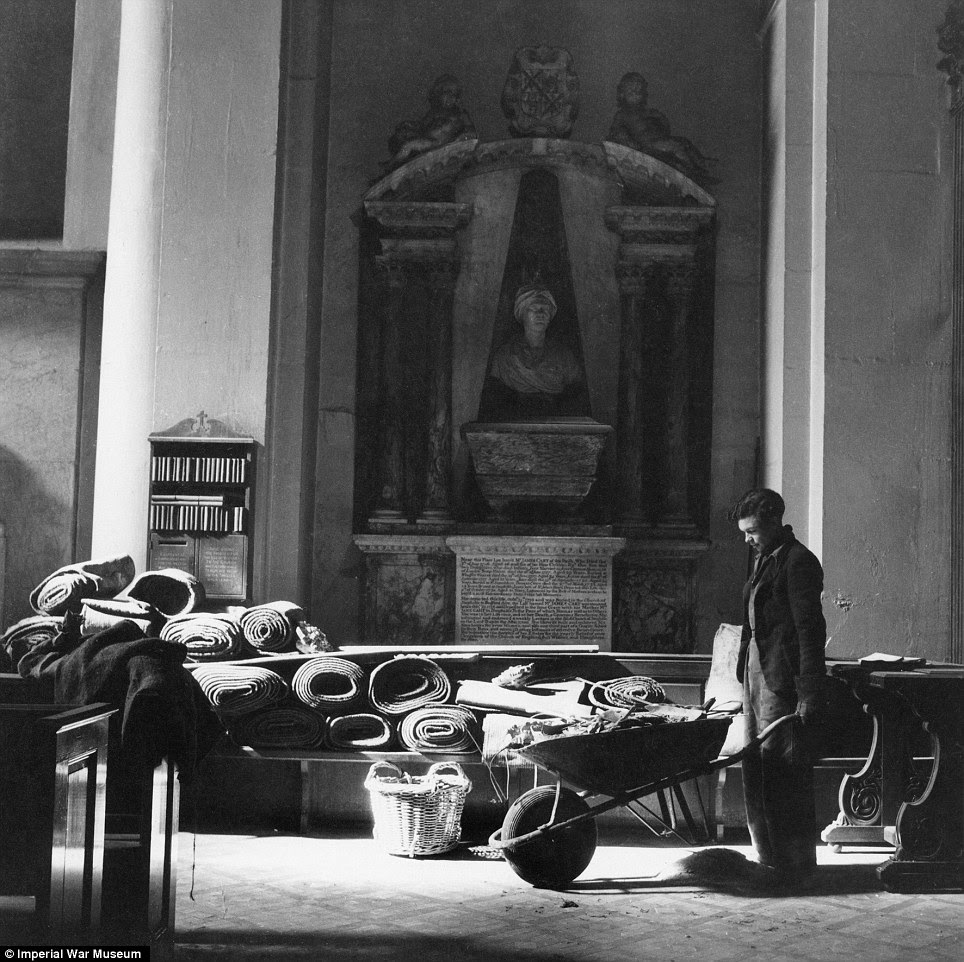 Blitz spirit: A workman clears debris from the floor of st Mary-le-Bow after its first bombing. The church was completed destroyed in 1942.