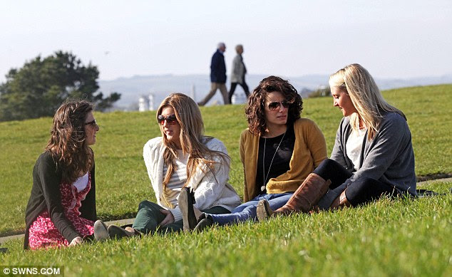 Sunny: Four young women enjoy the sunshine at Plymouth Hoe, Devon, today as Britain continues to enjoy an unusually warm winter