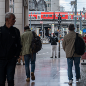 people walking on street by train track