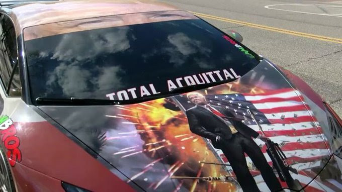 Car covered in ads.