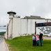 Laura Stapleton of Tampa, Fla., taking a selfie with family members on vacation at a newly erected sign at the Clinton Correctional Facility in Dannemora, N.Y.