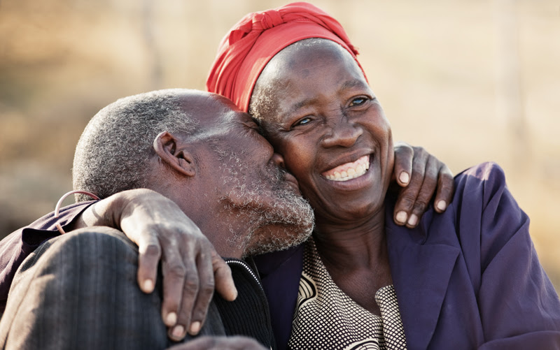 Two grandparents smiling