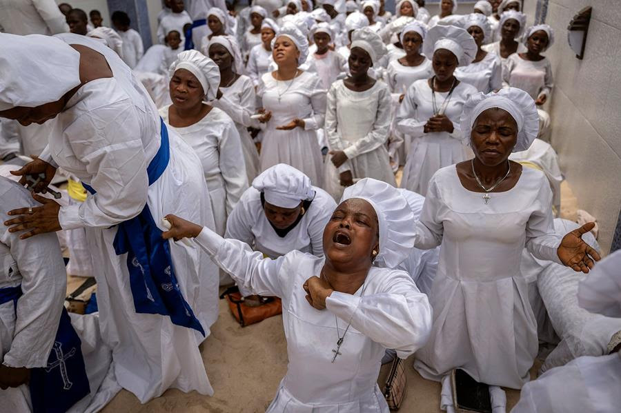 Members of the congregation of the Celestial Church of Christ Olowu Cathedral sing and chant during a church service.