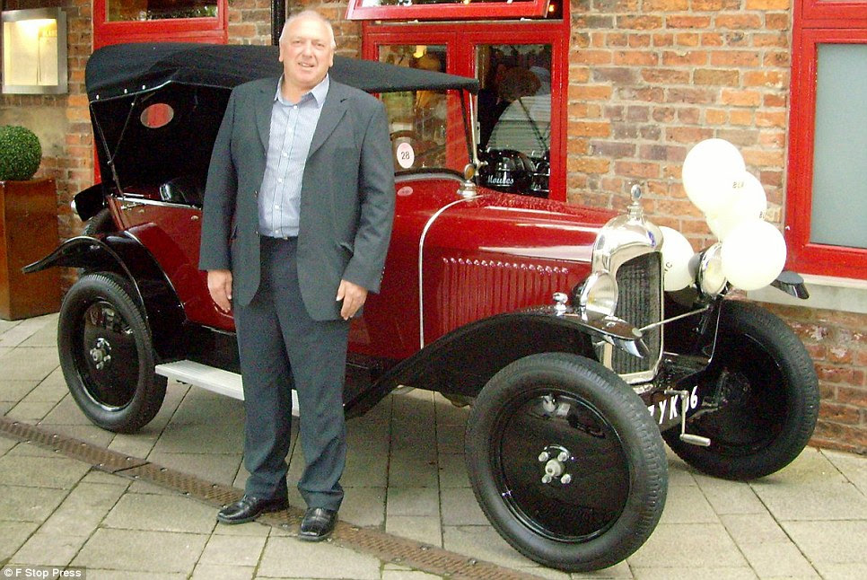 Owner of 2CV City, Tony Shields, is seen with another classic French car