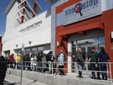 In this March 17, 2020, file photo, people wait in line for help with unemployment benefits at the One-Stop Career Center in Las Vegas. (AP Photo/John Locher, File)