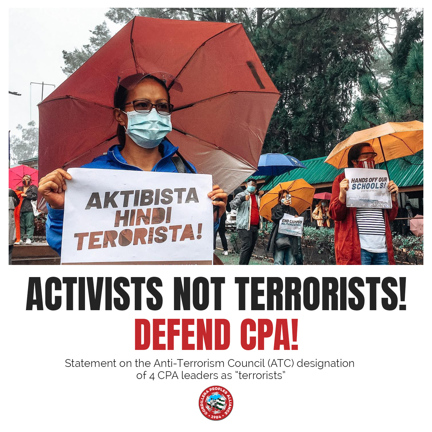 Woman holding a sign "Aktibsta Hindi Terorista". Translation: Activists not Terrorists! Defend CPA!