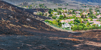 Wildfire burn area to the edge of suburban neighborhood in California. 