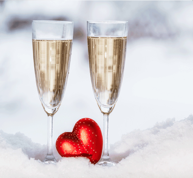 two champagne glasses in snow