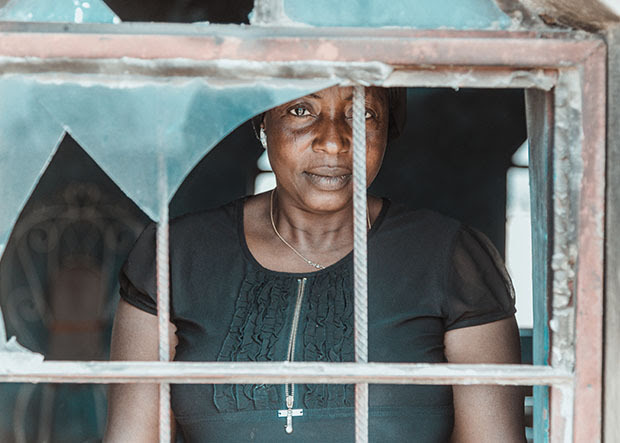 Woman smiling through window