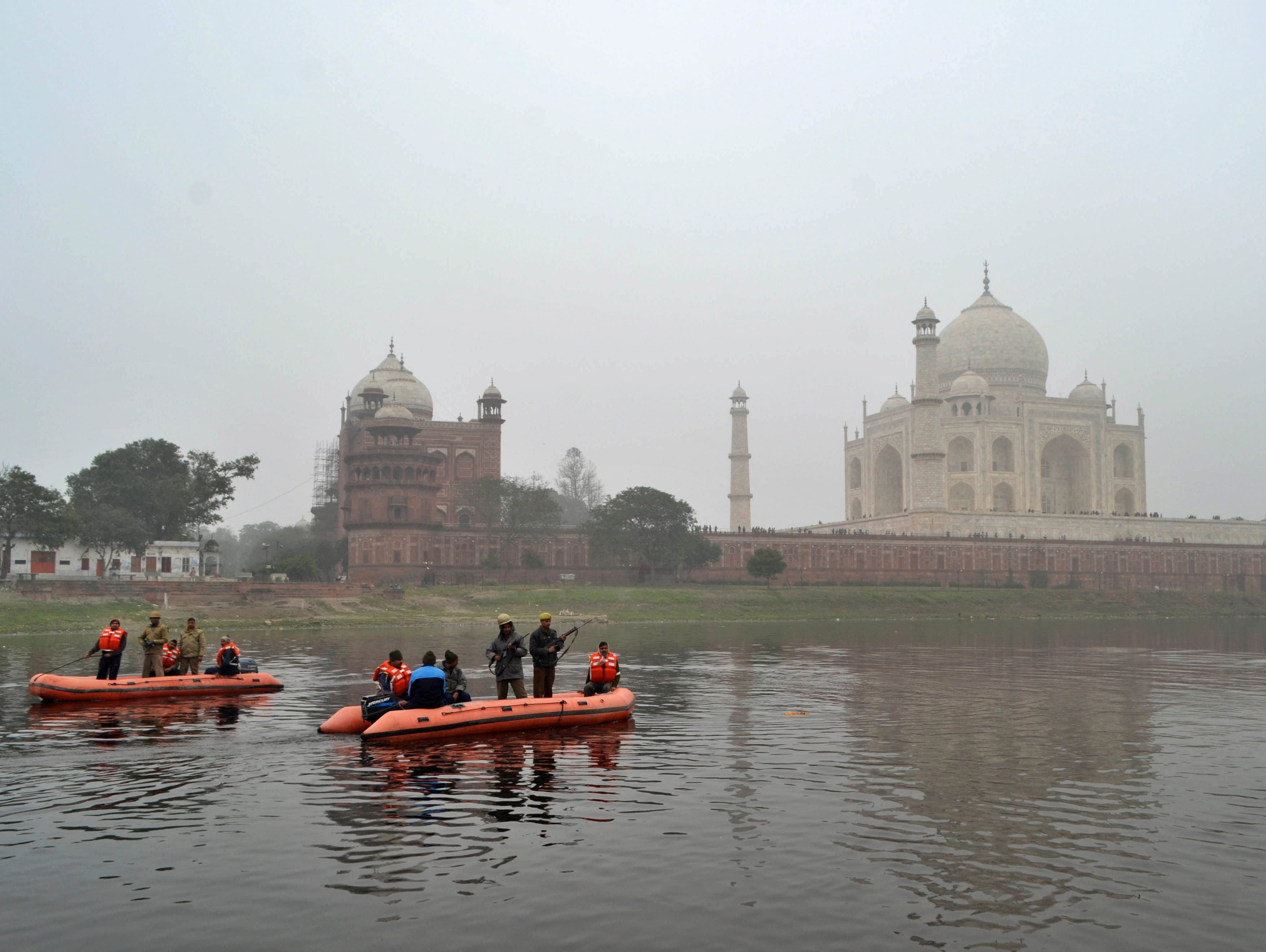 Indian policemen patrol through the Yamuna river passing the Taj Mahal monument in Agra, India, Saturday, Jan. 24, 2015. President Obama has cancelled his visit to the Taj Mahal during his stay in India in order to fly to Saudi Arabia.