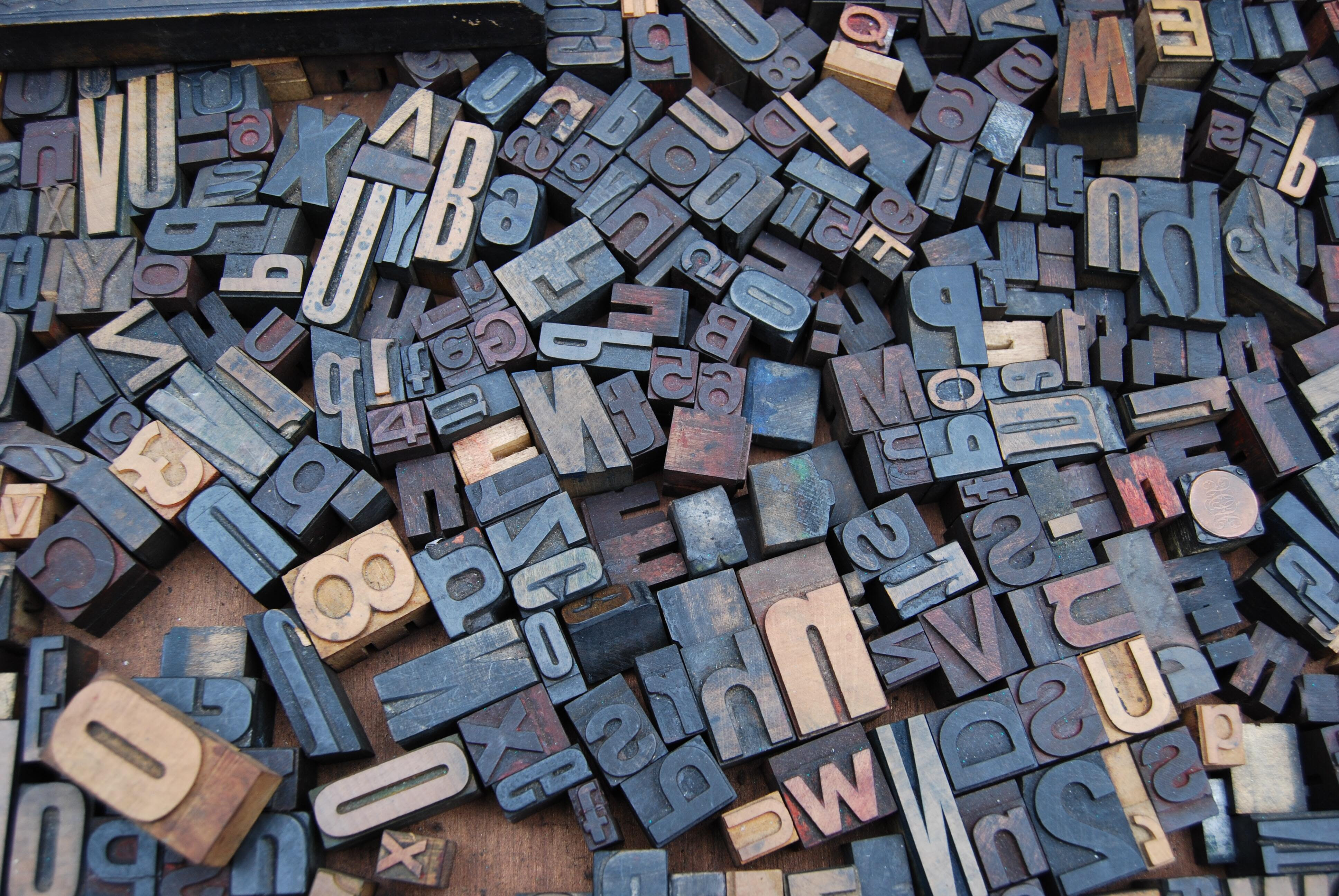 A photo of wooden printing letter blocks.
