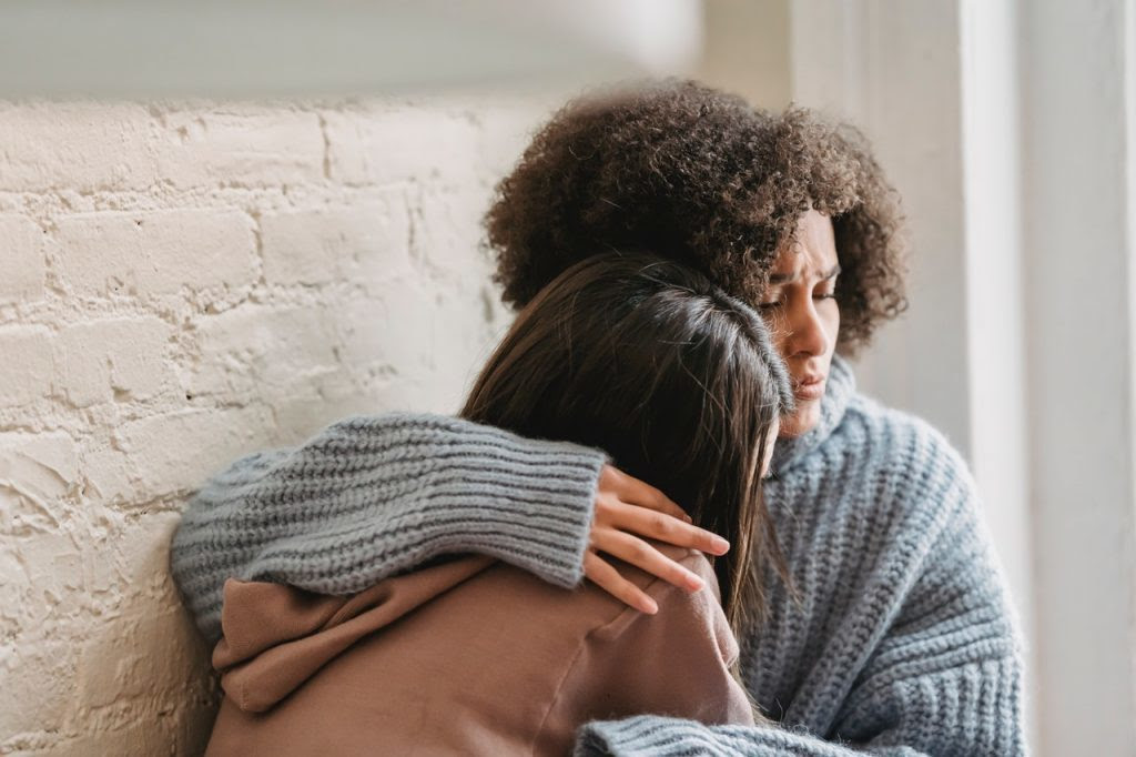 Women hugging.