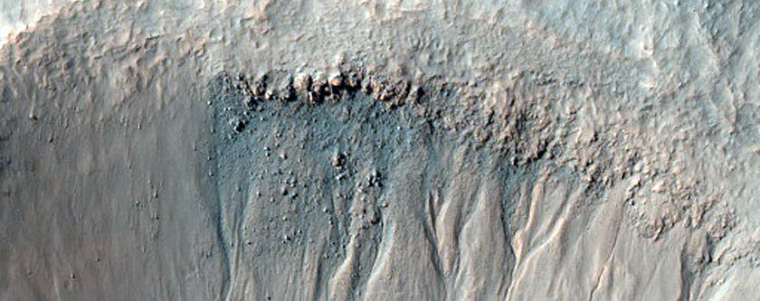 NASA keeps an eye of gullies like this for small landslides —and any water that melts in the warm sun to form darker-colored mud.