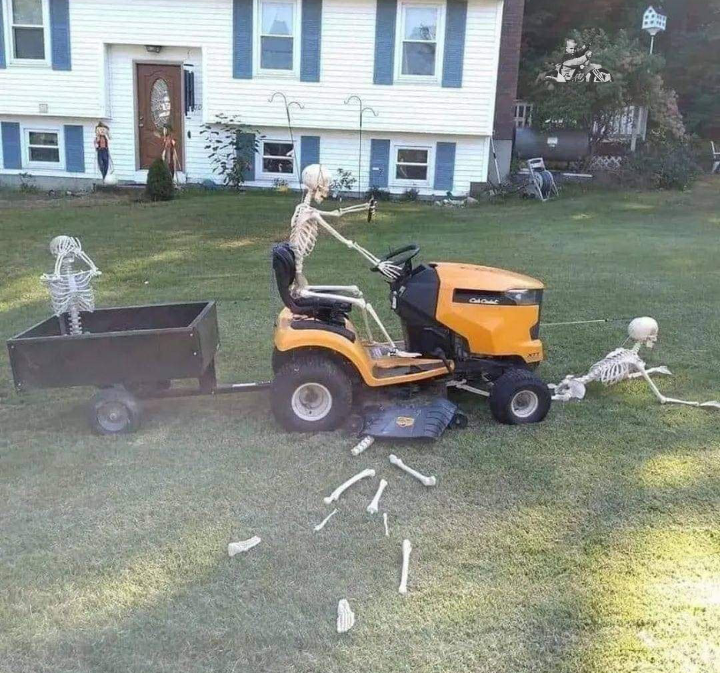 Funny bogis Halloween photo of skeltons being chopped up by lawnmower.