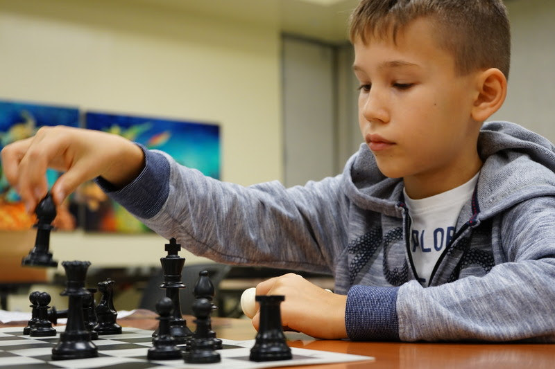 Young boy playing chess