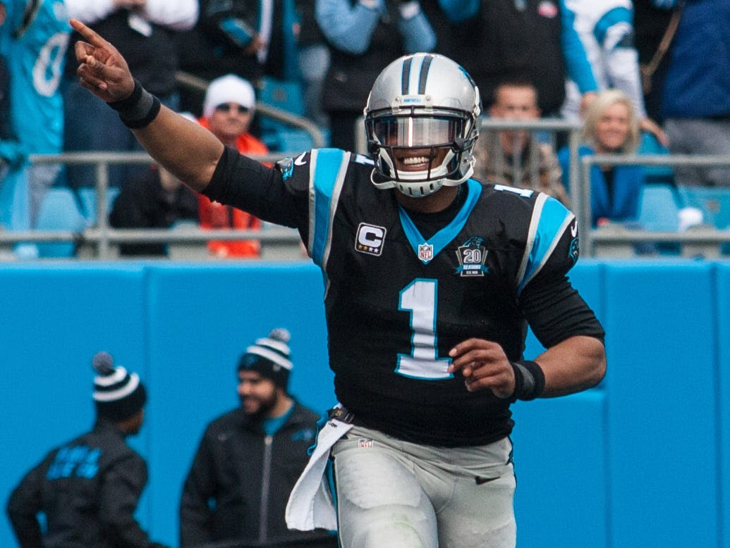 Dec 21, 2014; Charlotte, NC, USA; Carolina Panthers quarterback Cam Newton (1) celebrates after a touchdown during the second quarter against the Cleveland Browns at Bank of America Stadium. Mandatory Credit: Jeremy Brevard-USA TODAY Sports