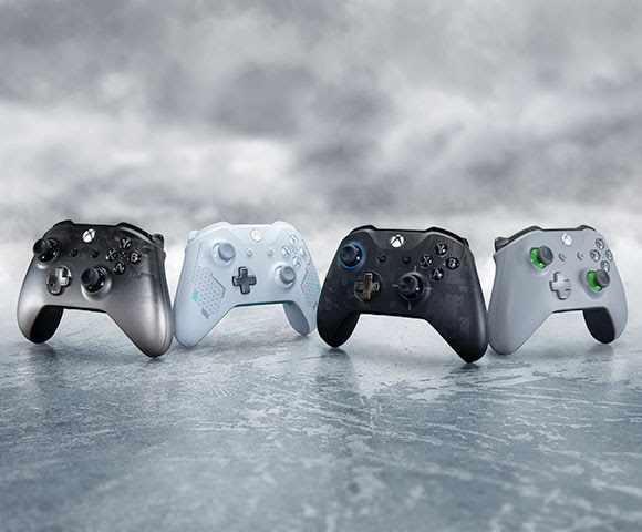 Four Xbox controllers aligned side by side.