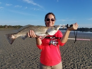 female holds spotted seatrout