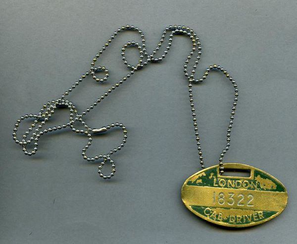 Brass badge on chain embossed with the words London Cab Driver 18322