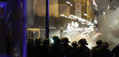 Fireworks explode as policemen stand by during protests in Roubaix, northern France on June 30, 2023, three days after a teenager was shot dead during a police traffic stop in the Paris suburb of Nanterre. Protests over the fatal police shooting of a teenager rocked France for a third straight night on June 29, with cars burned, buildings vandalised and hundreds arrested in cities across the country.
The nighttime unrest followed a march earlier on Thursday in memory of the 17-year-old, named Nahel, whose death has revived longstanding grievances about policing and racial profiling in France's low-income and multiethnic suburbs. (Photo by Kenzo TRIBOUILLARD / AFP)