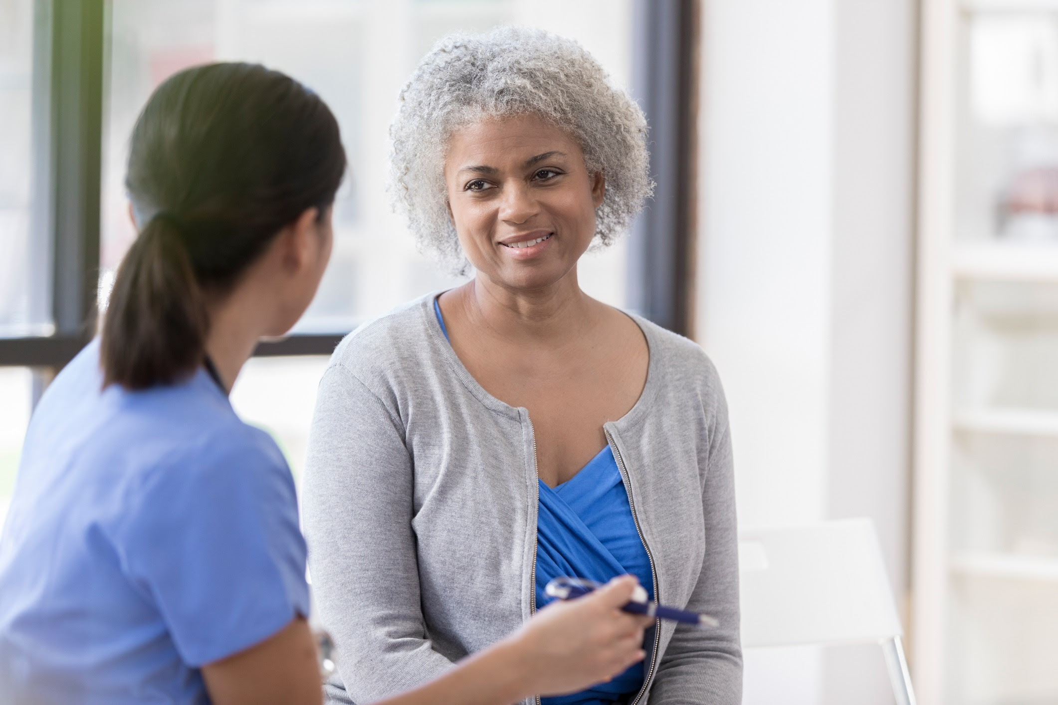 Woman talking with health care worker