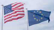 U.S. and EU flags waving in the breeze.