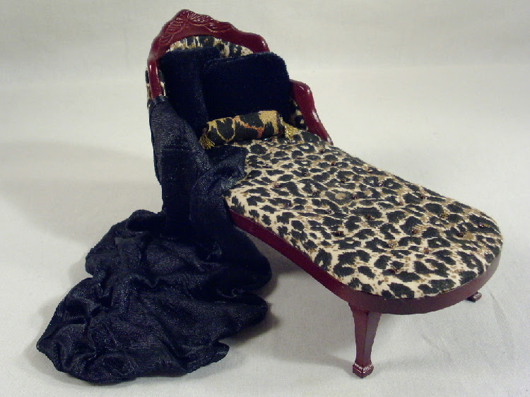The curved wood framing of the chaise has been bleached and distressed to add to the character of this piece. Dollhouse Miniature Leopard Print Chaise Lounge