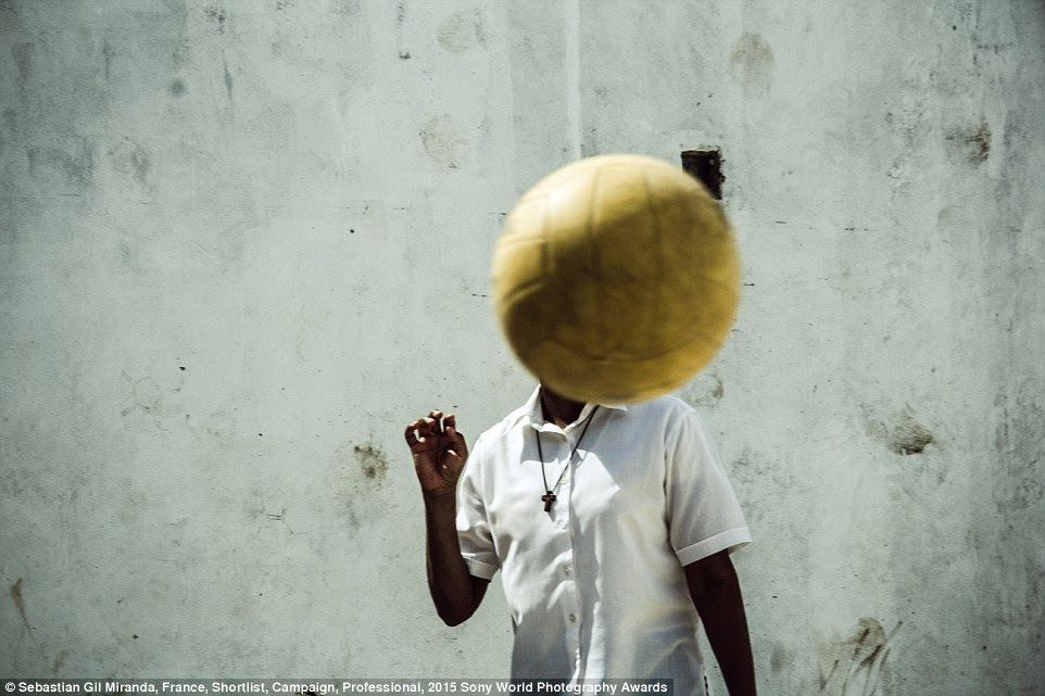 Shoot ball, not gun: A boy plays football in Villa La Carcova, one of the most dangerous slums of Buenos Aires, Argentina