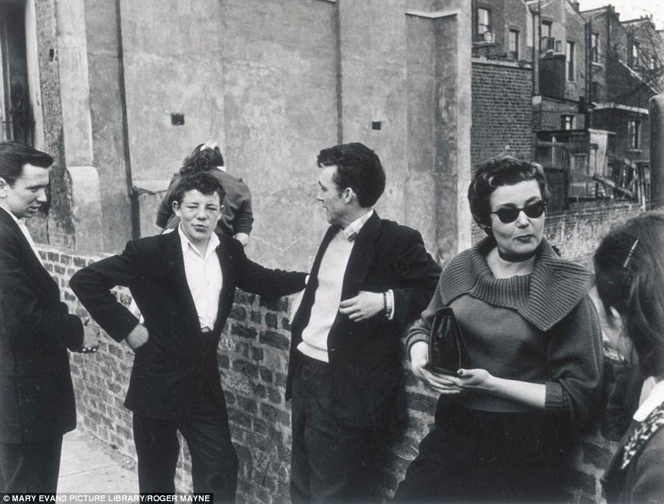 Working class youngsters hang out together in a west London street in 1956