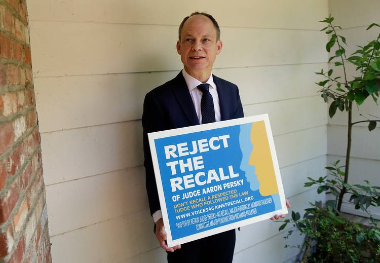 Judge Aaron Persky poses for a photo with a lawn sign opposing his recall in Los Altos Hills, Calif. (Jeff Chiu/AP)
