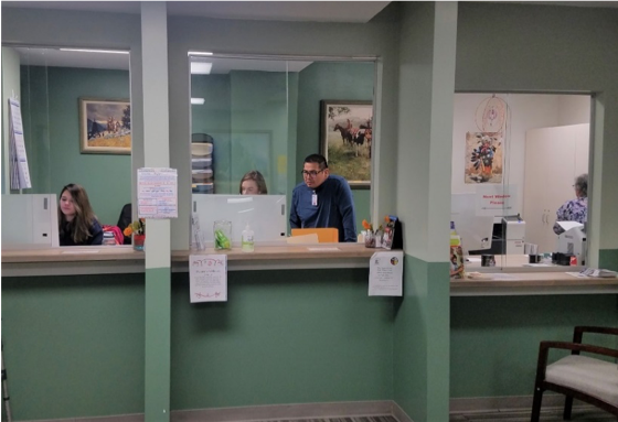 Image of Helena Indian Alliance's renovated reception area. It features privacy barriers for patients, a station for people who need to sit, and new equipment for staff.