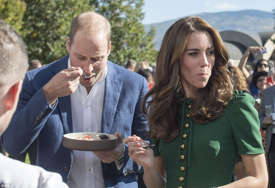 Kate looks a little unsure as she samples one local dish - although William seems more than happy to give it a try