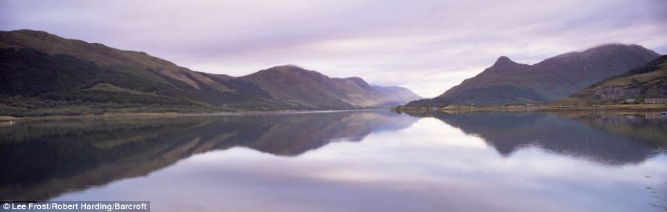 Misty mountains: A panoramic view of a shimmering Loch Leven in Glencoe village near Fort William, Highland region of Scotland