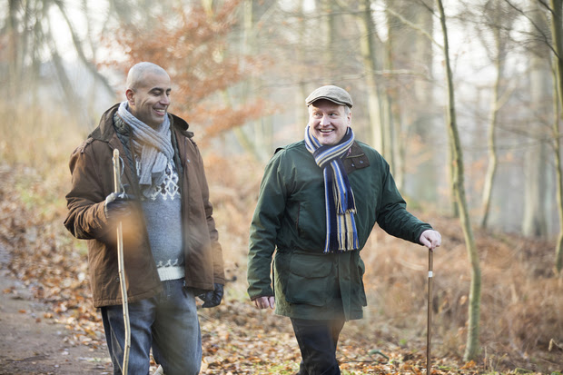 Two older men taking a winter walk together.