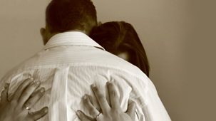 Sepia image of a couple crying. 