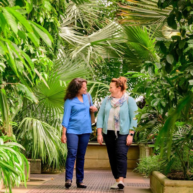 Two Women walking through the Palm House