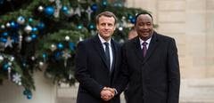 (FILES) French President Emmanuel Macron (L) greets Niger President Mahamadou Issoufou upon his arrival at the Elysee palace on December 12, 2017 in Paris, for a lunch as part of the One Planet Summit. France has suspended all development aid and budgetary support to Niger following a military coup against President Mohamed Bazoum, the French foreign ministry said on July 29, 2023. (Photo by CHRISTOPHE ARCHAMBAULT / AFP)