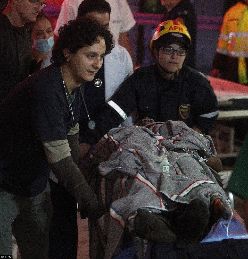 Medical staff from the San Juan de Dios hospital transfer 27-year-old Brazilian footballer Alan Ruschel after he as pulled alive from the wreckage of the crash