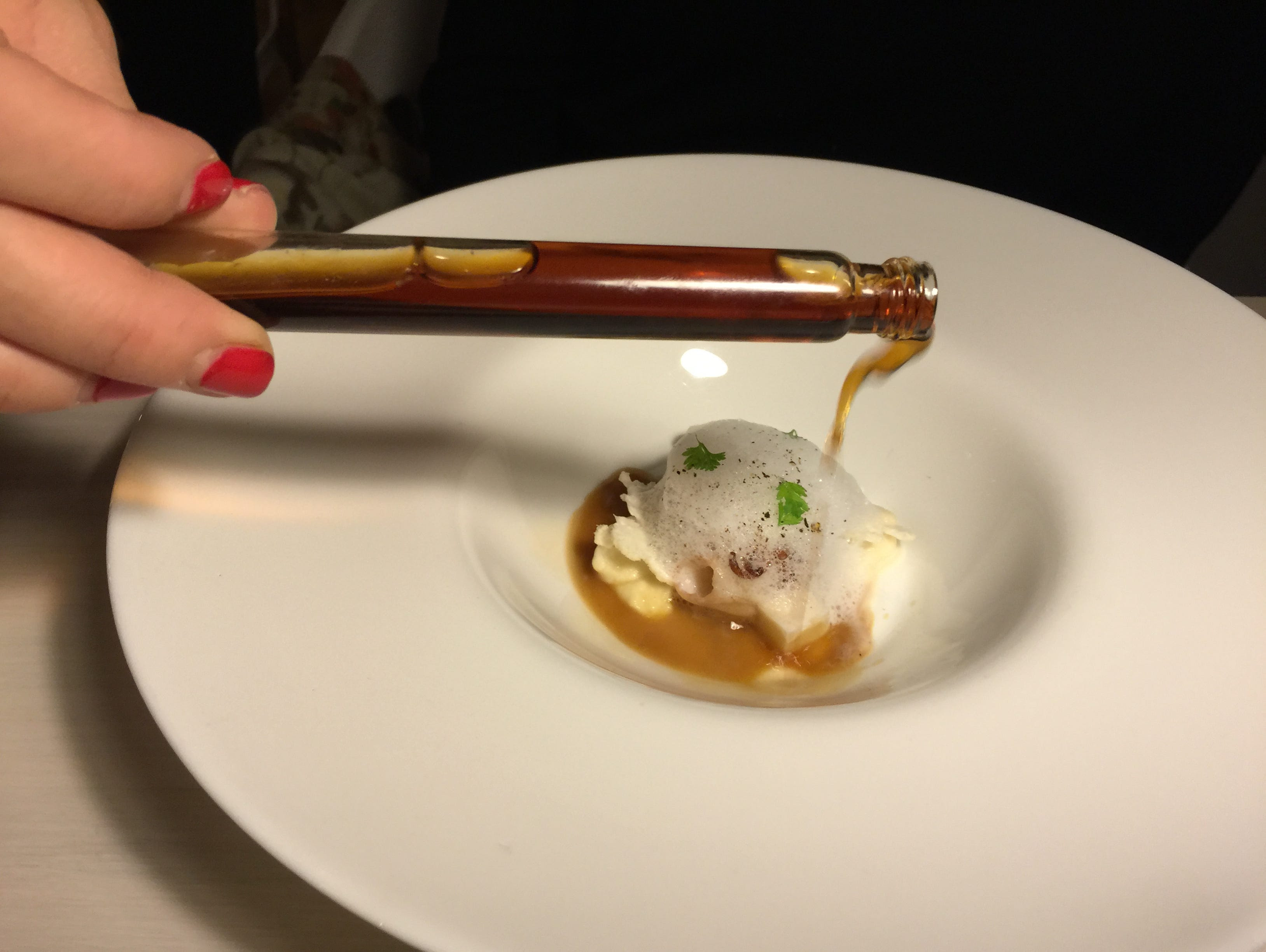 Touches of foam top off calamarcitos salteados (sautéed baby squid with cauliflower flan and purée with black pepper foam) at Madrid’s nouvelle cuisine restaurant Al Trapo by Paco Morales. A sauce is poured over the foam atop the sautéed baby squid c