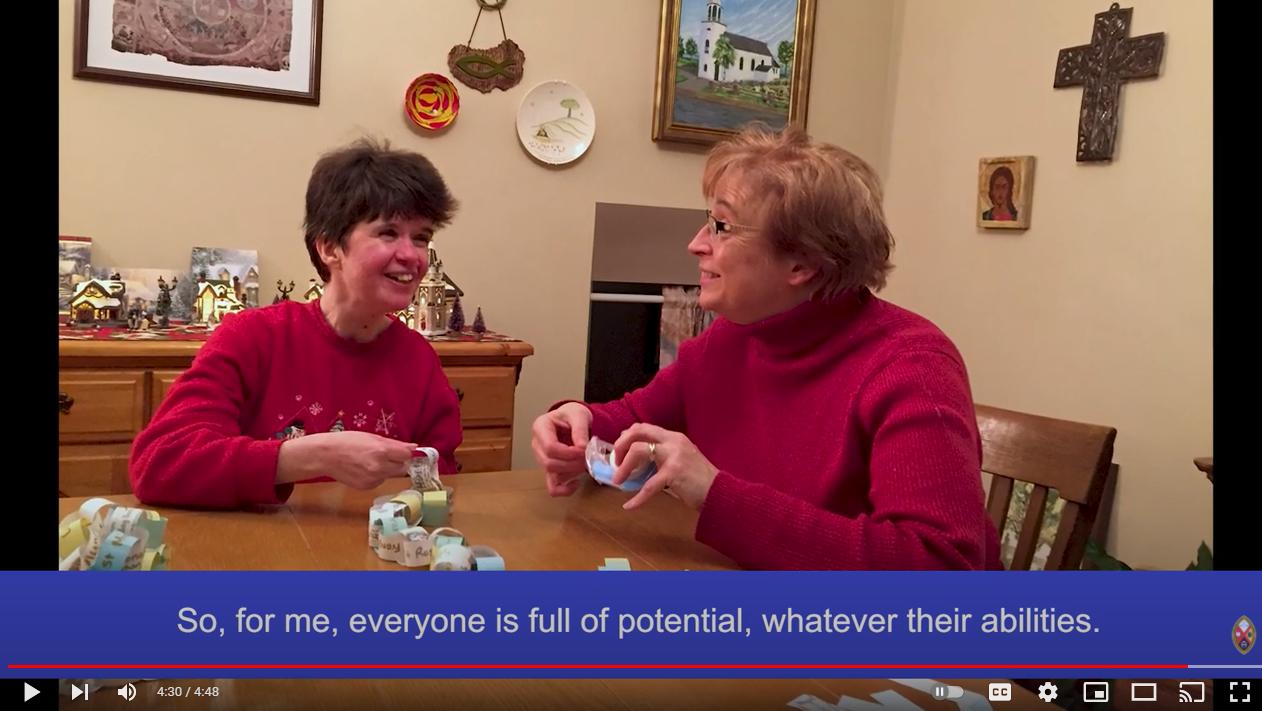 Still image from the video, showing Darla and Catherine making Christmas decorations together.