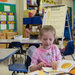 Marisa Garza, 5, working on an assignment at Riverside Elementary School in Menomonee Falls, Wis. The board behind her encouraged the 