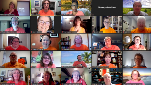 Photo of a Zoom meeting in which the participants are wearing orange shirts.