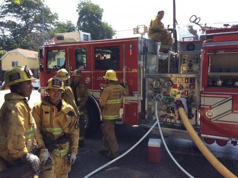 Firefighters in front of an Engine.